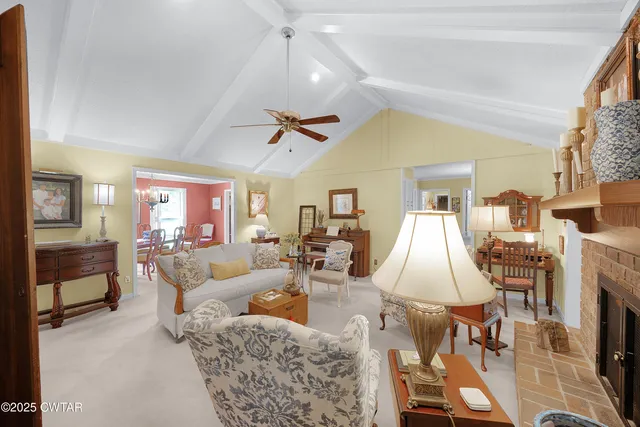 a living room with furniture dining table and a chandelier