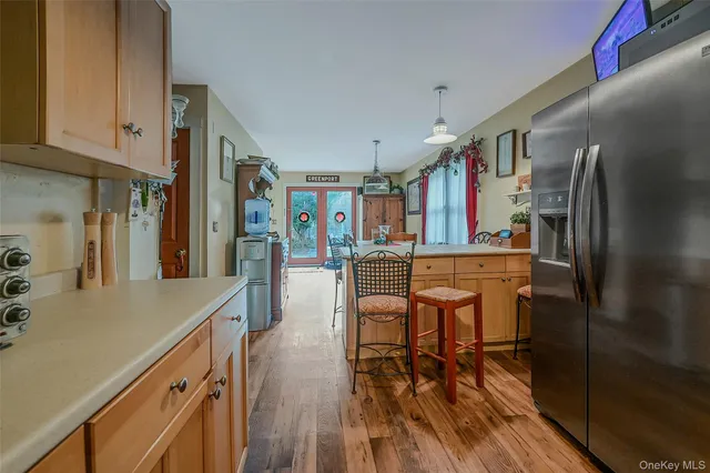 a kitchen with stainless steel appliances granite countertop a refrigerator a stove and a wooden floors