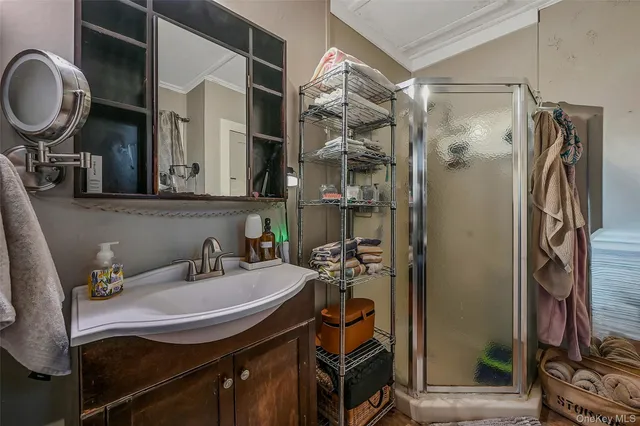 a bathroom with a sink a mirror and shower