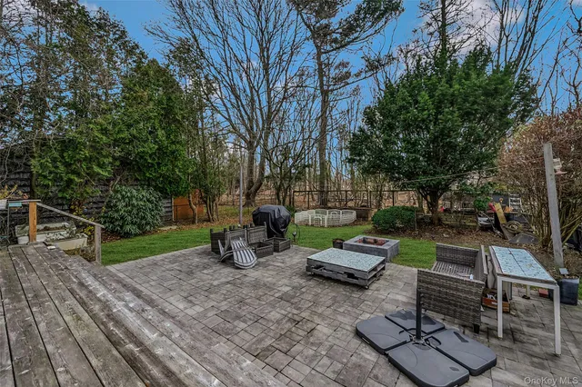 a view of a backyard with sitting area