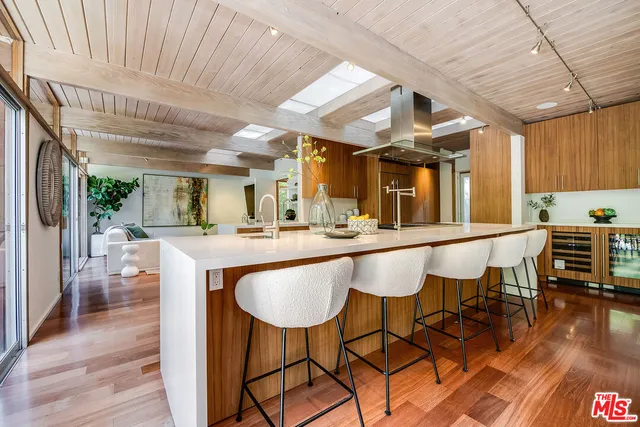 a large kitchen with stainless steel appliances a sink and counter space