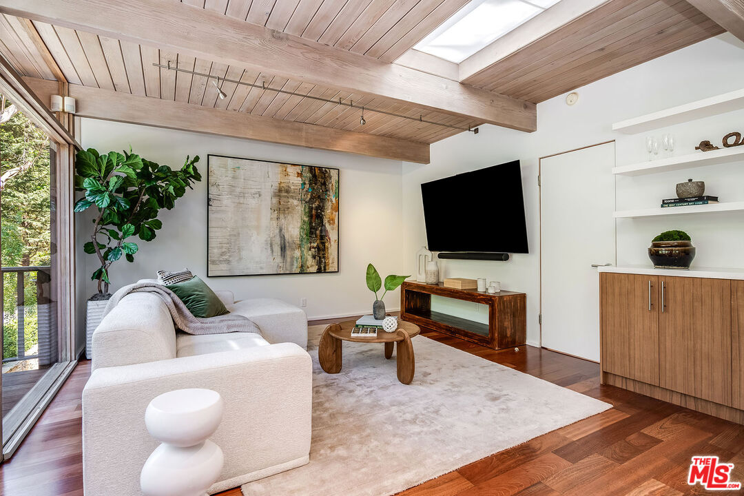 681 Brooktree Road Santa Monica, CA 90402 - Photo 18 of 33 a living room with furniture and a flat screen tv