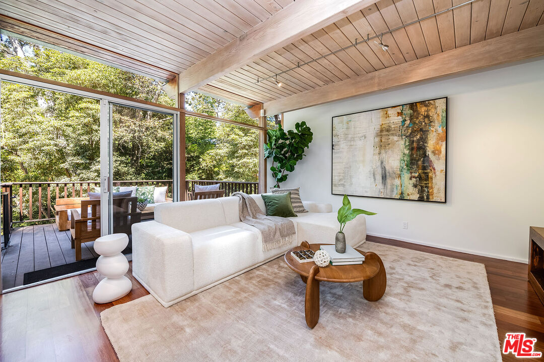 681 Brooktree Road Santa Monica, CA 90402 - Photo 19 of 33 a living room with furniture and a large window