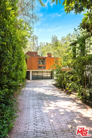 a pathway of a house with a yard