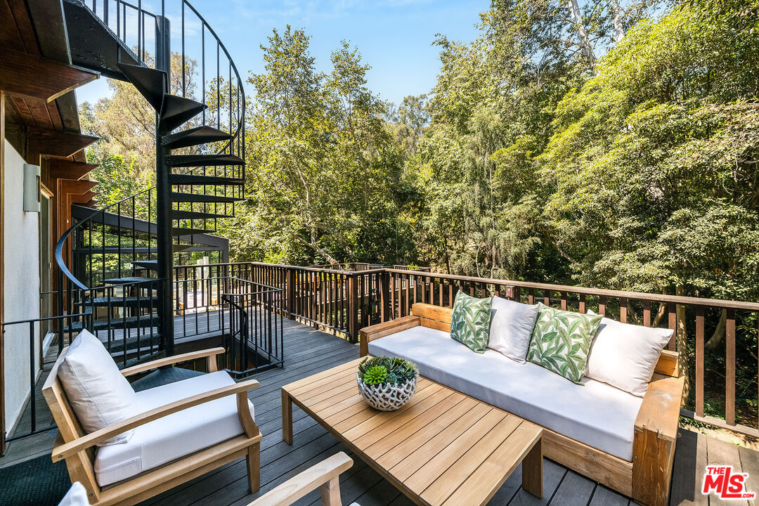 681 Brooktree Road Santa Monica, CA 90402 - Photo 21 of 33 a view of a balcony with wooden floor and outdoor seating