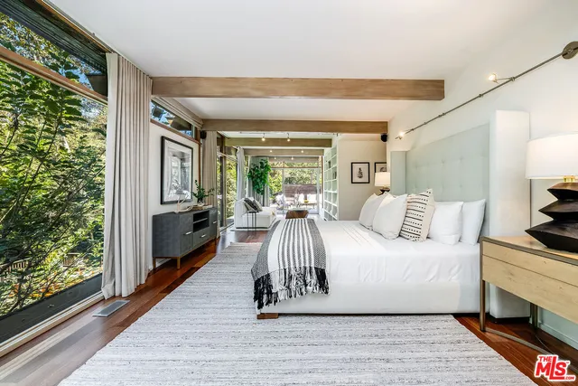 a outdoor view with a sitting space and trees