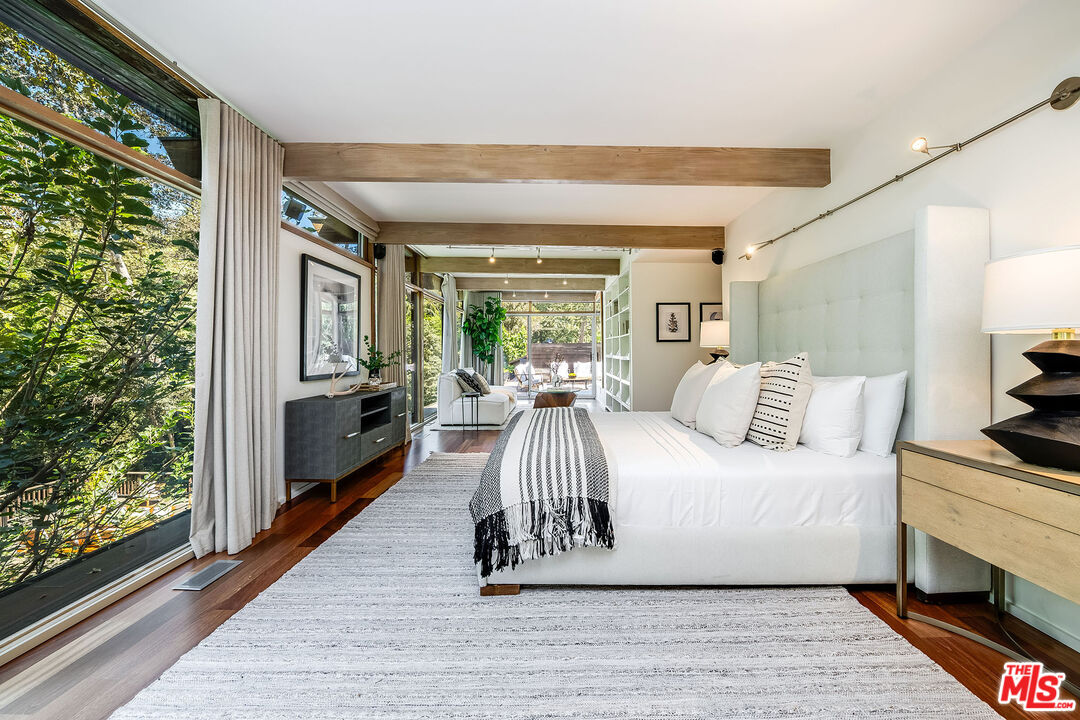 681 Brooktree Road Santa Monica, CA 90402 - Photo 27 of 33 a spacious bedroom with a bed and a large window