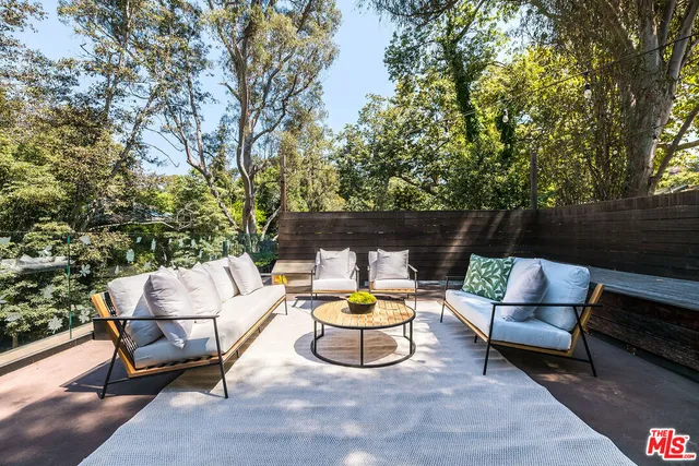 a view of swimming pool with sitting area and garden