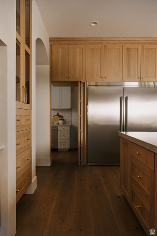 2281 South Crimson Cliffs Way St. George, UT 84790 - Photo 17 of 47 Kitchen with stainless steel built in fridge, dark wood-style flooring, wood finish cabinetry, and arched walkways