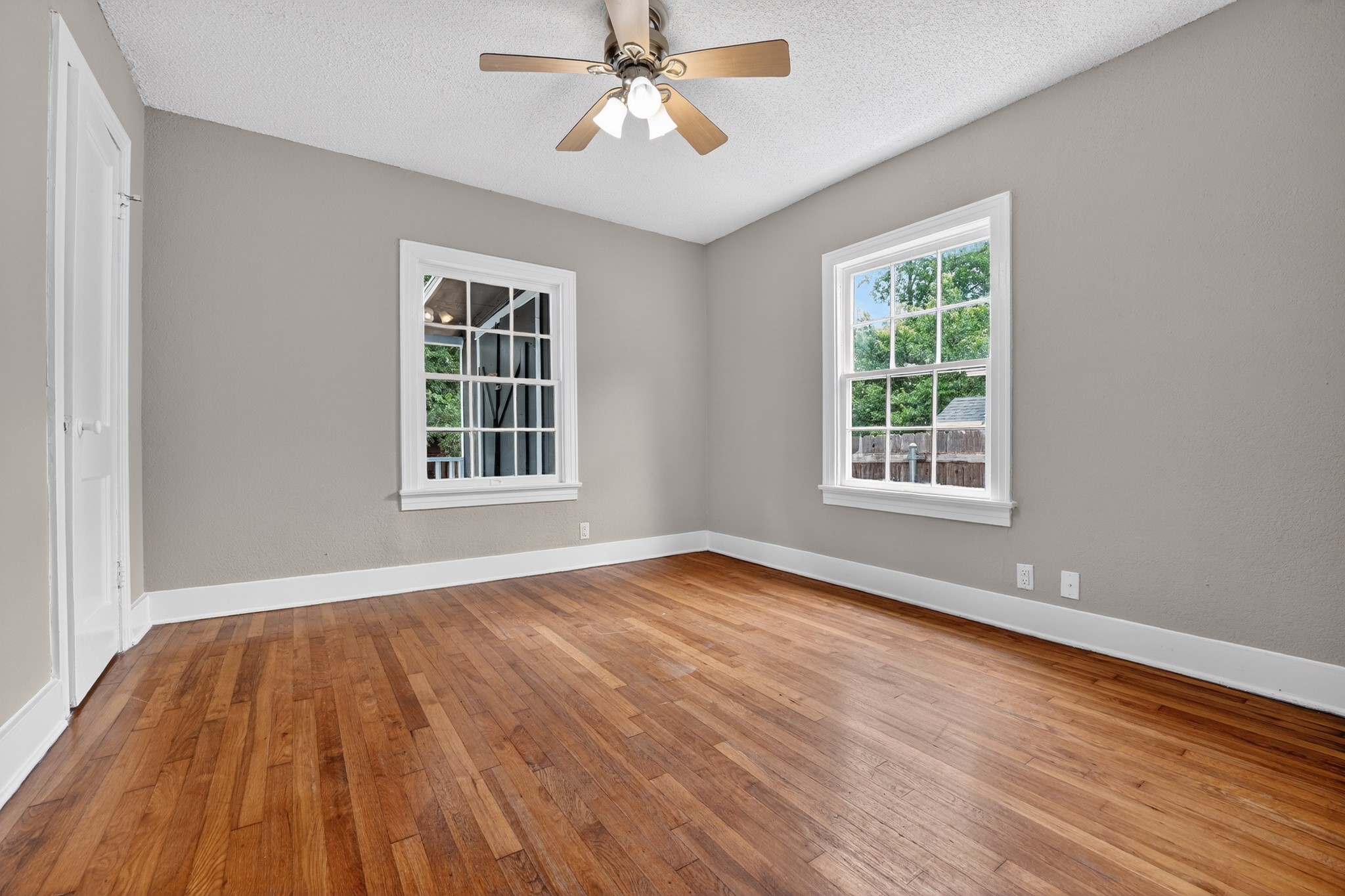 4907 Duval Street Austin, TX 78751 - Photo 18 of 31 a view of an empty room with wooden floor and a window