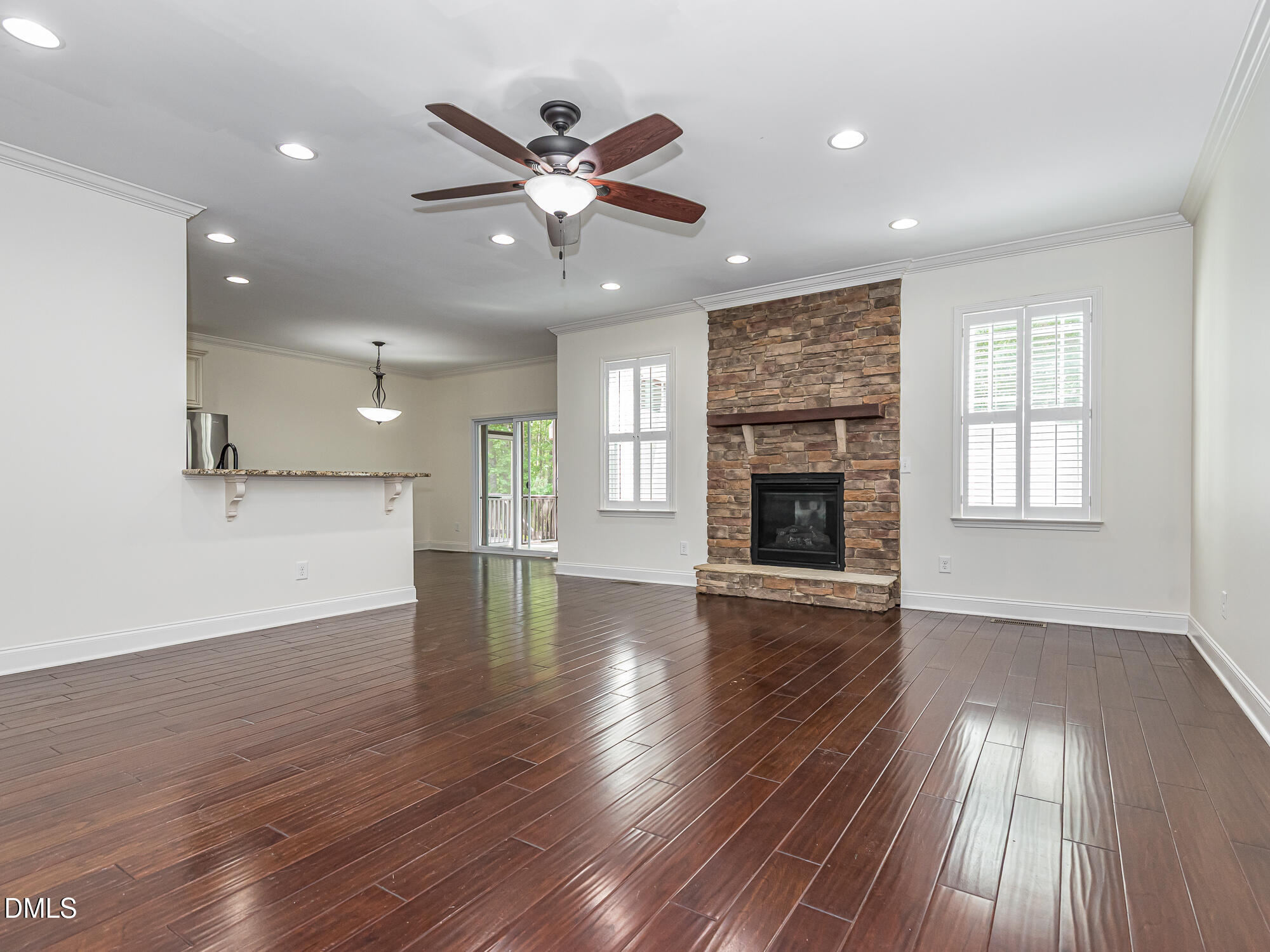 337 Shadowdale Lane Rolesville, NC 27571 - Photo 5 of 42 an empty room with wooden floor fireplace and windows