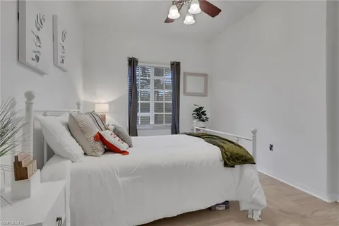 a bedroom with a bed and window