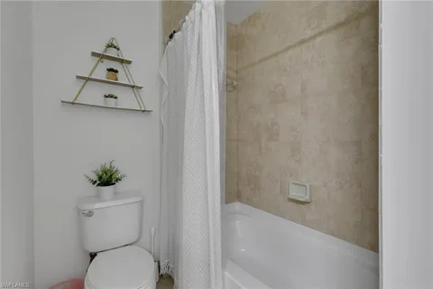 a bathroom with a sink a toilet and bathtub