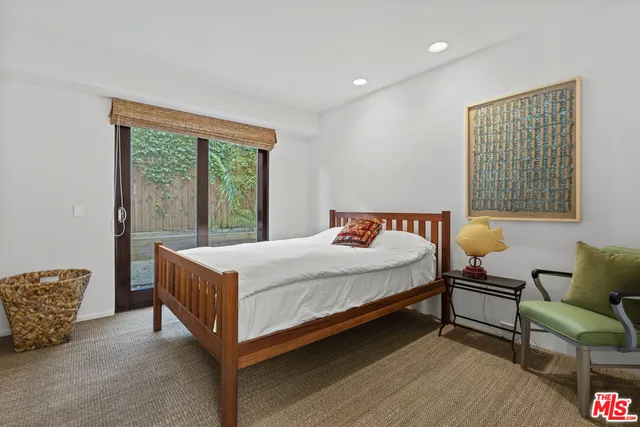 a bedroom with a bed and glass window