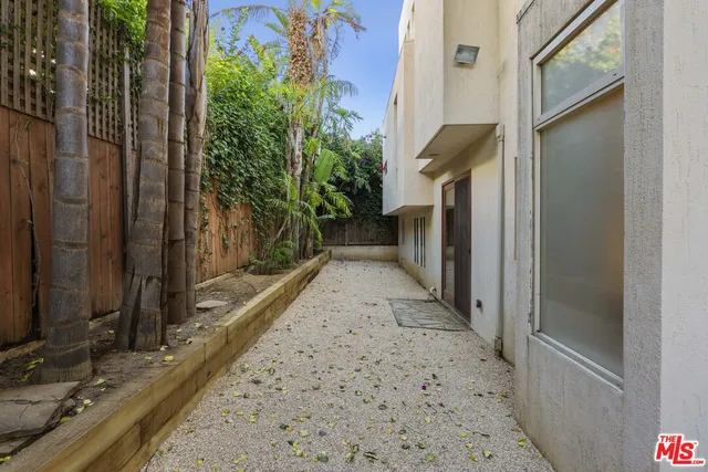 a outdoor dining space with furniture and potted plants