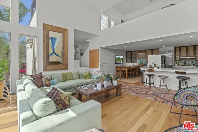 a kitchen with stainless steel appliances granite countertop a sink and a refrigerator