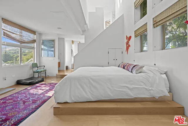 a bedroom with a bed and window