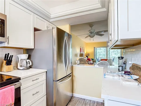 a kitchen with a sink appliances and cabinets