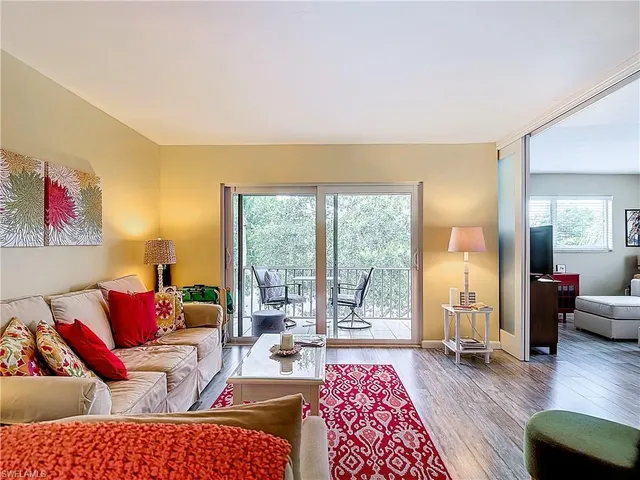 a living room with furniture or couch and a large window