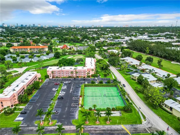 an aerial view of residential houses with outdoor space and street view