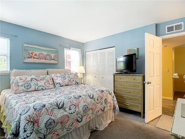 a bedroom with a large bed and a window