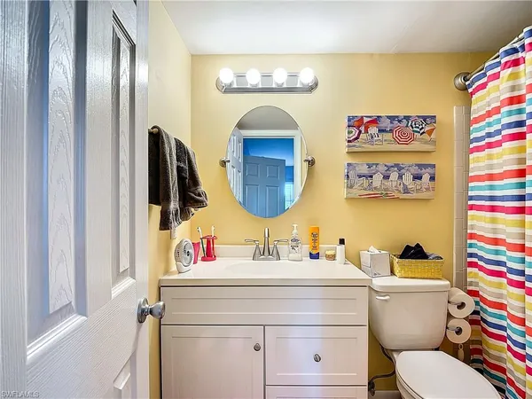 a bathroom with a sink a mirror and a shower curtain