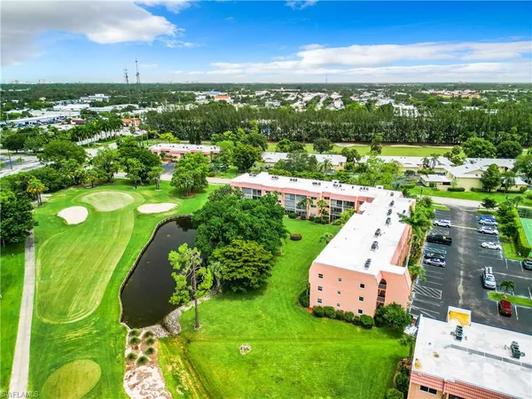 an aerial view of residential houses with outdoor space and trees