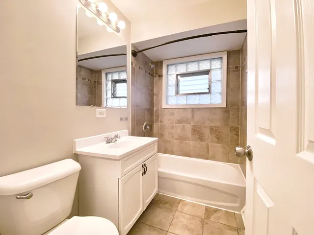 a bathroom with a sink a toilet and bathtub