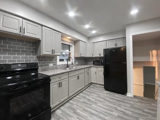 a kitchen with a sink stove and refrigerator