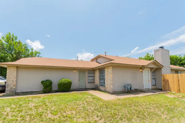 a view of a house with a yard and garage