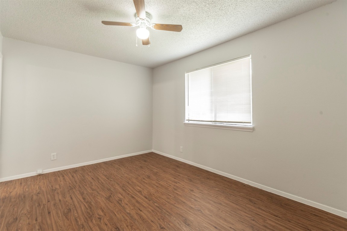 2300 Misty Morning Way, Unit A Round Rock, TX 78664 - Photo 12 of 16 wooden floor in an empty room with a window