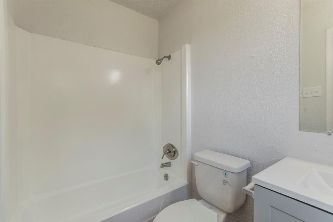 2300 Misty Morning Way, Unit A Round Rock, TX 78664 - Photo 14 of 16 a white toilet sitting next to a bath tub
