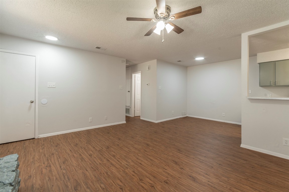 2300 Misty Morning Way, Unit A Round Rock, TX 78664 - Photo 3 of 16 an empty room with wooden floor and ceiling fan