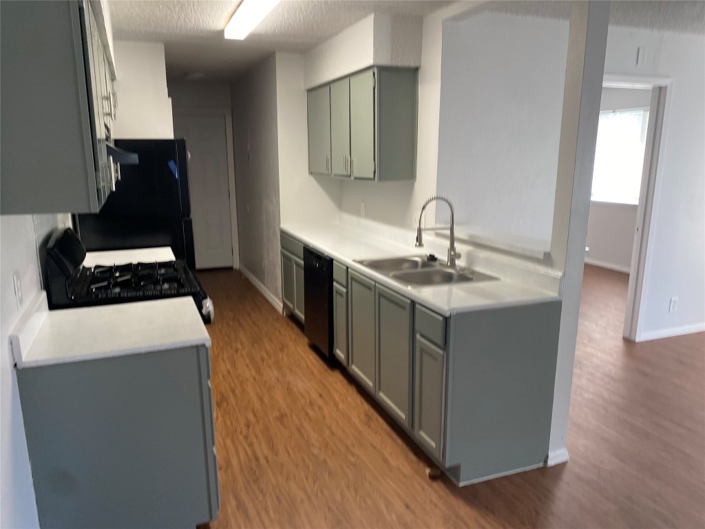 2300 Misty Morning Way, Unit A Round Rock, TX 78664 - Photo 6 of 16 a kitchen with stainless steel appliances granite countertop a sink stove and wooden floor