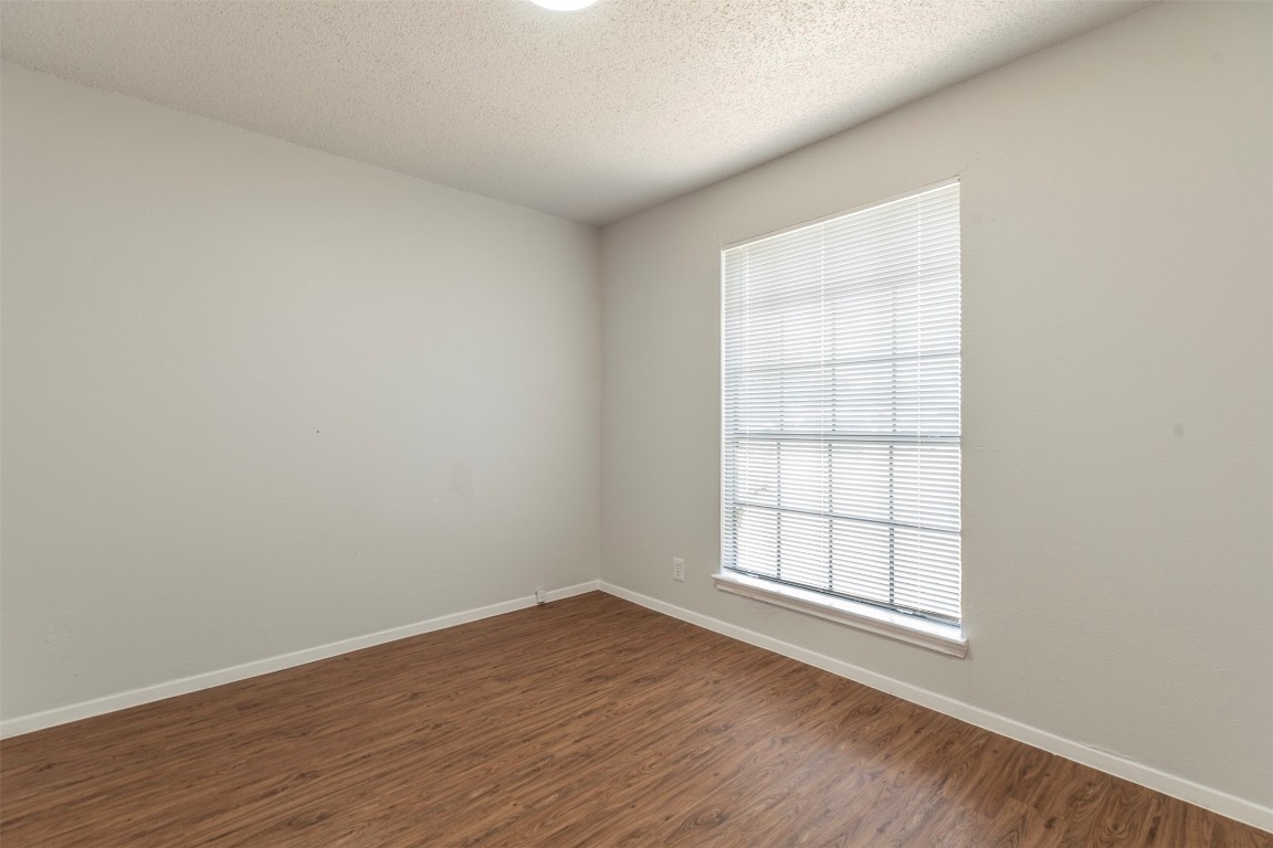 2300 Misty Morning Way, Unit A Round Rock, TX 78664 - Photo 7 of 16 an empty room with wooden floor and windows