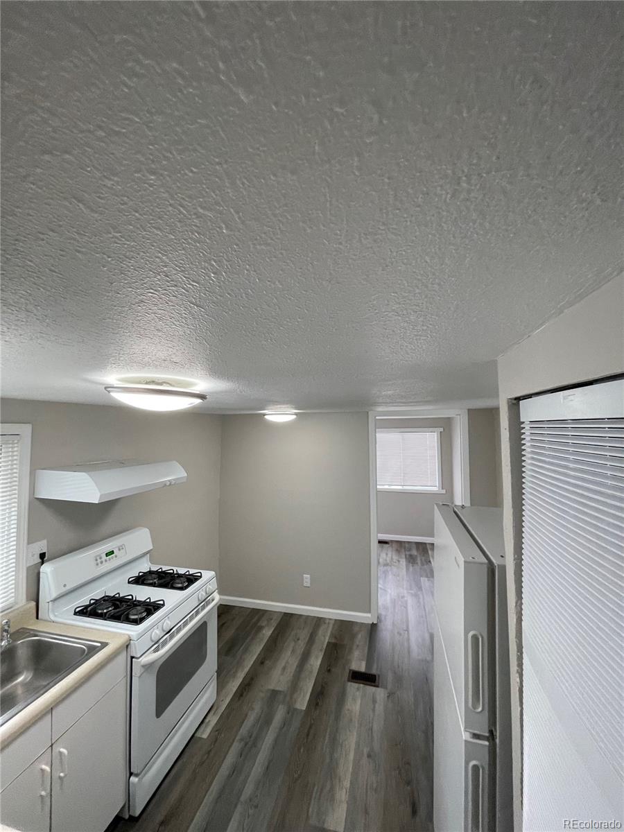 a kitchen with a stove and a refrigerator