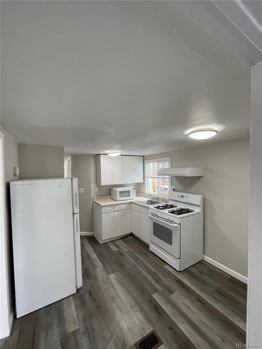 275 Junction Loop Road Empire, CO 80438 - Photo 6 of 18 a kitchen with a stove top oven and refrigerator