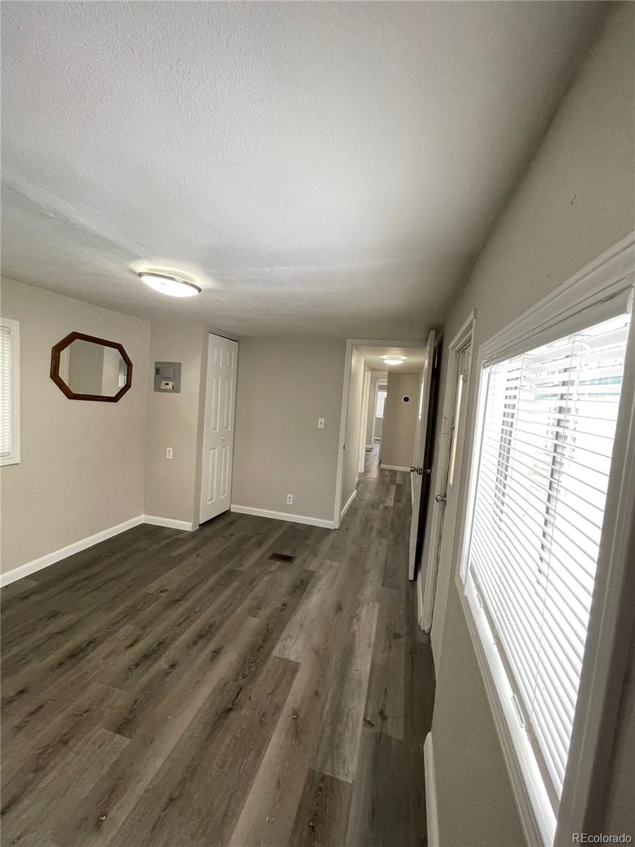 275 Junction Loop Road Empire, CO 80438 - Photo 8 of 18 a view of a hallway with wooden floor and staircase