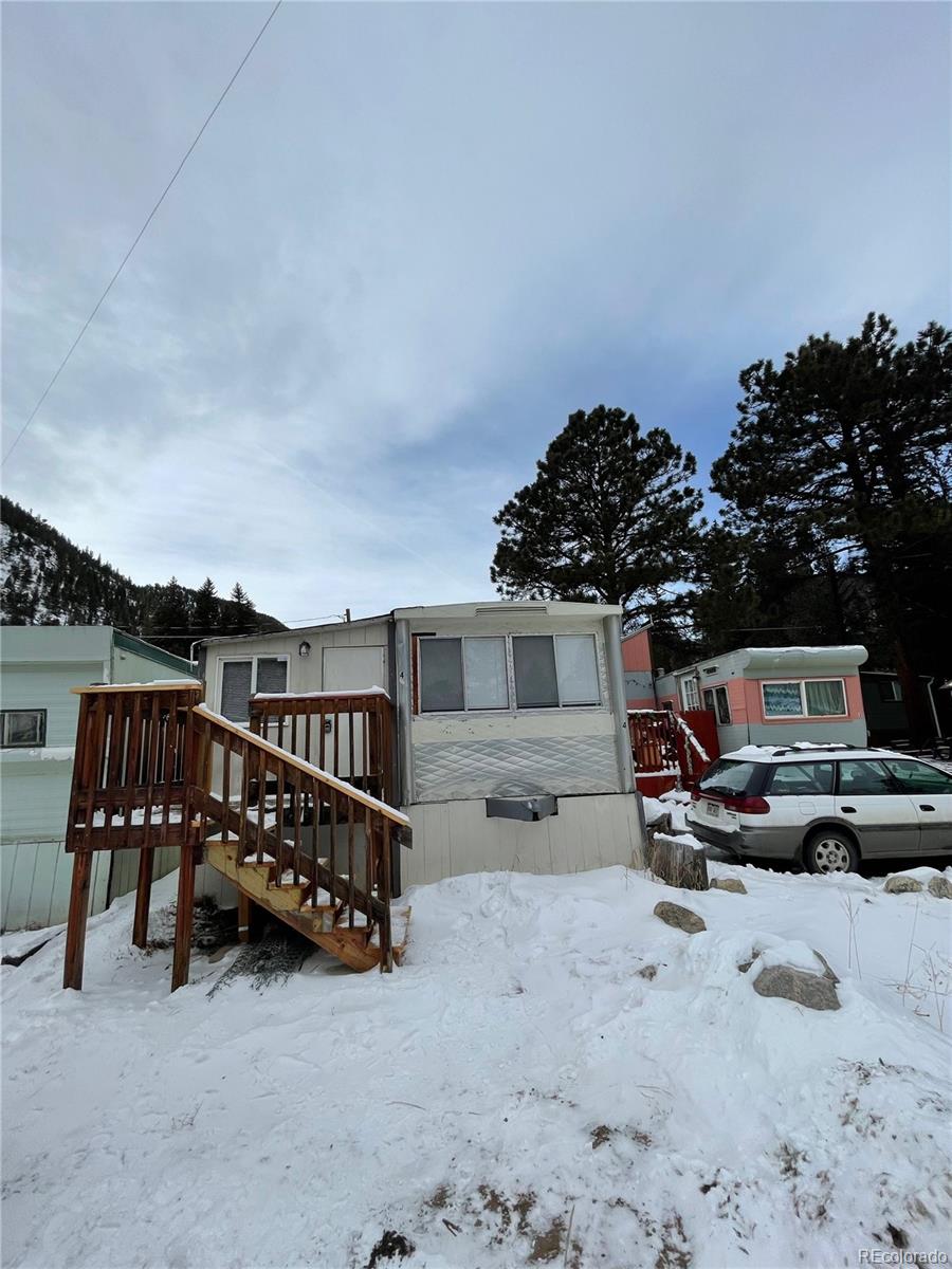 275 Junction Loop Road Empire, CO 80438 - Photo 9 of 18 a view of a roof deck with table and chairs a barbeque