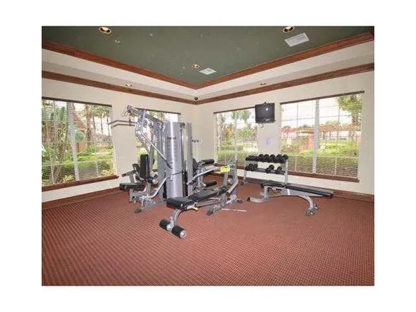 a room with gym equipment and a large window
