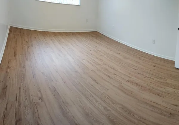 a view of a room with wooden floor