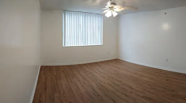 a view of a room with wooden floor and chandelier