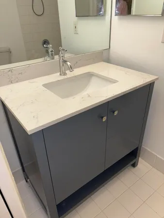a bathroom with a sink vanity and a mirror