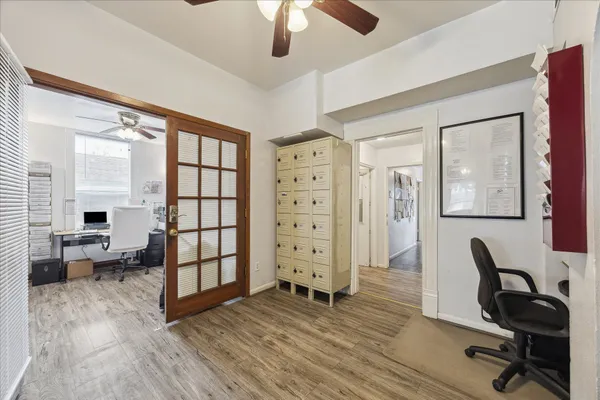 a view of entryway and hall with wooden floor