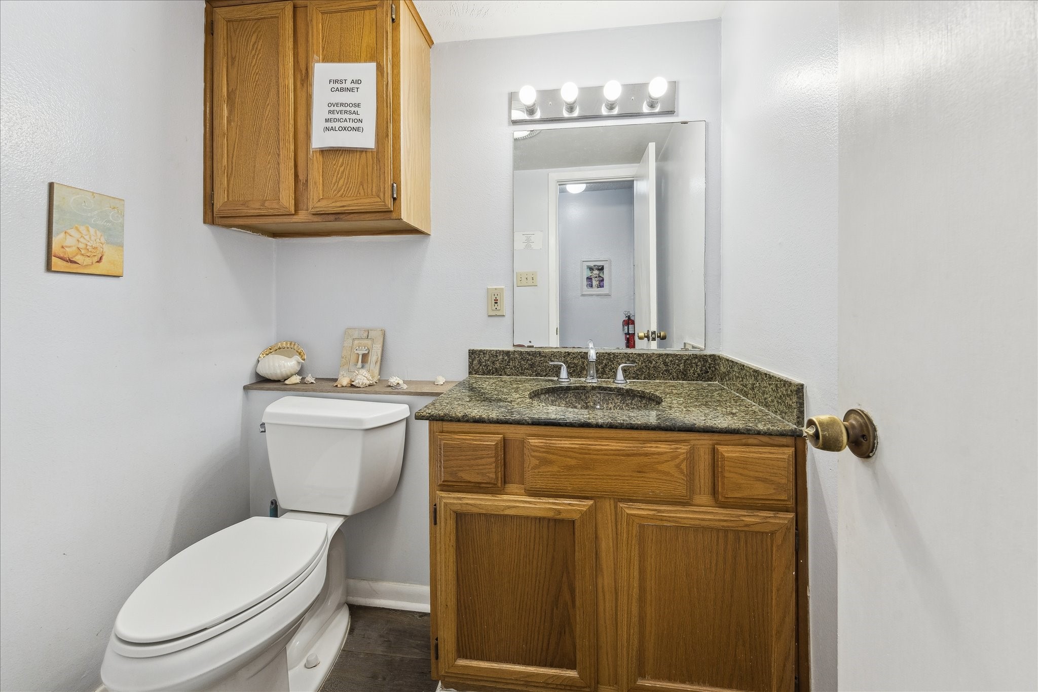 240 West 23rd Street Houston, TX 77008 - Photo 19 of 31 a bathroom with a granite countertop toilet sink and mirror