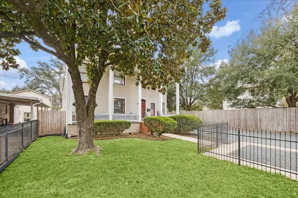 a view of backyard of house with green space