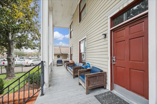a view of outdoor seating space with wooden floor and stairs