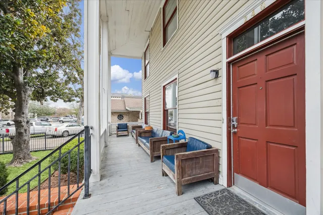 a view of outdoor seating space with wooden floor and stairs