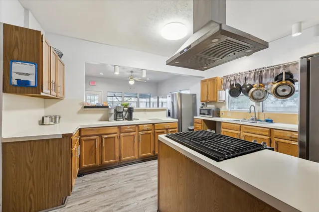 a kitchen with stainless steel appliances a stove a sink and a refrigerator