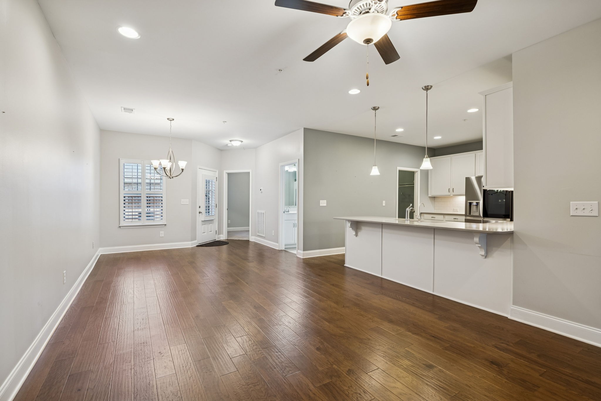352 Buckner Cir Mount Mount Juliet, TN 37122 - Photo 13 of 51 a view of an empty room and kitchen with wooden floor